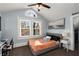 Cozy bedroom with blue walls, natural light from the windows, and a gray upholstered bed at 166 Erie Ave, Decatur, GA 30030