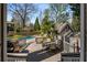 Outdoor deck with seating area and grill overlooking the pool and lush backyard at 166 Erie Ave, Decatur, GA 30030