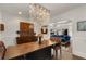 View of the dining room featuring an elegant chandelier, wooden table, and seating area at 166 Erie Ave, Decatur, GA 30030