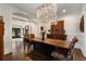 Spacious dining room featuring a wooden table, modern chandelier, and hardwood floors at 166 Erie Ave, Decatur, GA 30030