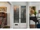Elegant entryway with antique mirrored doors, artwork and hardwood floors at 166 Erie Ave, Decatur, GA 30030