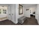 Hallway featuring neutral walls, carpeting, a storage bench, and doorways to other rooms at 166 Erie Ave, Decatur, GA 30030