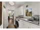 Well-lit laundry room with modern washer/dryer, granite countertop, and ample cabinet space at 166 Erie Ave, Decatur, GA 30030