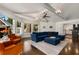 Open-concept living room with hardwood floors, a blue sectional sofa, and a view into the kitchen at 166 Erie Ave, Decatur, GA 30030