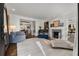 Spacious living room with a fireplace, piano, and stylish decor, perfect for relaxation and entertaining guests at 166 Erie Ave, Decatur, GA 30030