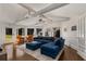 Bright living room featuring vaulted ceilings, exposed beams, large windows, and a comfortable blue sectional at 166 Erie Ave, Decatur, GA 30030