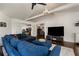 Open-concept living room with hardwood floors, a blue sectional sofa, and a view into the kitchen at 166 Erie Ave, Decatur, GA 30030