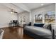 Bright living room with hardwood floors, daybed sofa, and natural light from large windows at 166 Erie Ave, Decatur, GA 30030