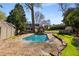 Backyard features a sparkling pool, custom stone patio, a pool house, lush landscaping, ideal for entertaining guests at 166 Erie Ave, Decatur, GA 30030