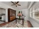 Bright sunroom with decorative cabinet, many windows and table and seating area at 166 Erie Ave, Decatur, GA 30030