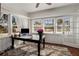 Sunroom featuring many windows providing natural light, and a table with an elegant flower arrangement at 166 Erie Ave, Decatur, GA 30030