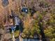 Aerial view of the property showing the house surrounded by lush trees and a driveway at 7427 Hollis Rd, Douglasville, GA 30135