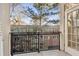 Outdoor balcony area with iron railing and views of the surrounding foliage at 825 Highland Ne Ln # 1206, Atlanta, GA 30306