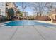 Wide angle shot of the pool area which has a winter pool cover with a view of the residential buildings in the background at 825 Highland Ne Ln # 1206, Atlanta, GA 30306