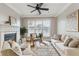 Inviting living room with a cozy fireplace, neutral tones, and a modern ceiling fan at 825 Highland Ne Ln # 1206, Atlanta, GA 30306