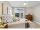 Comfortable main bedroom featuring neutral colors, french doors, and ample closet space at 825 Highland Ne Ln # 1206, Atlanta, GA 30306