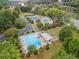 Aerial view of community pool, playground, clubhouse, and tennis court at 9570 Huntcliff Trce, Atlanta, GA 30350