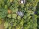 A house is surrounded by lush trees, offering privacy and a sense of seclusion at 9570 Huntcliff Trce, Atlanta, GA 30350