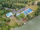 Aerial view of pool, tennis court, and lake at 9570 Huntcliff Trce, Atlanta, GA 30350