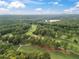 An aerial view of the neighborhood featuring a lake and a golf course at 9570 Huntcliff Trce, Atlanta, GA 30350