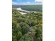 An aerial perspective of a home in a leafy neighborhood, close to a river at 9570 Huntcliff Trce, Atlanta, GA 30350