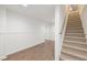 Spacious unfinished basement with wood floors and carpeted stairs leading upstairs at 9570 Huntcliff Trce, Atlanta, GA 30350