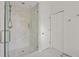 Bathroom featuring glass enclosed shower and white cabinets for storage at 9570 Huntcliff Trce, Atlanta, GA 30350