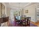 Elegant dining room with large windows, hardwood floors, and a chandelier at 9570 Huntcliff Trce, Atlanta, GA 30350