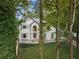 Charming two-story traditional home with manicured landscaping and mature trees at 9570 Huntcliff Trce, Atlanta, GA 30350