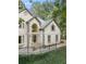 Traditional two-story home with bay windows, arched entryway, and manicured landscaping at 9570 Huntcliff Trce, Atlanta, GA 30350