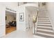 Bright foyer with staircase, white trim and tile floors at 9570 Huntcliff Trce, Atlanta, GA 30350