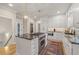 Well-appointed kitchen featuring an island cooktop, stainless appliances, white cabinets, and granite countertops at 9570 Huntcliff Trce, Atlanta, GA 30350