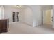 Living Room features French doors, neutral paint colors, and plush carpet at 9570 Huntcliff Trce, Atlanta, GA 30350