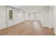 Bright and airy living room with hardwood floors, white walls, and elegant white curtains at 9570 Huntcliff Trce, Atlanta, GA 30350