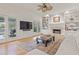 Bright living room with hardwood floors, built-in bookshelves, fireplace, and french doors to the patio at 9570 Huntcliff Trce, Atlanta, GA 30350
