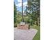 Stone patio features a built-in outdoor kitchen with a grill and lush green landscaping at 9570 Huntcliff Trce, Atlanta, GA 30350