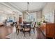 Spacious dining room with a large table, a chandelier, hardwood floors, and an adjacent living area at 2720 Rustic Lake Ter, Cumming, GA 30041