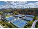 Aerial view of tennis courts surrounded by lush trees with a view of the city skyline in the background at 2484 Oldfield Nw Rd, Atlanta, GA 30327