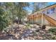 Expansive backyard with brick patio, Adirondack chairs, a hammock, and stairs leading to an upper deck at 2484 Oldfield Nw Rd, Atlanta, GA 30327