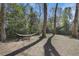 Backyard featuring mature trees, a well maintained lawn, and a relaxing hammock at 2484 Oldfield Nw Rd, Atlanta, GA 30327