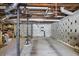 Unfinished basement with exposed pipes, concrete walls, and a support beam at 2484 Oldfield Nw Rd, Atlanta, GA 30327