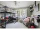 Eclectic bedroom featuring a lofted bed, work space, and playful decor at 2484 Oldfield Nw Rd, Atlanta, GA 30327