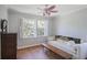 Cozy bedroom featuring a daybed, hardwood floors, and bright natural light at 2484 Oldfield Nw Rd, Atlanta, GA 30327