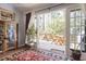 View of a wooden deck area with a table and chairs extending off the living area through a sliding glass door at 2484 Oldfield Nw Rd, Atlanta, GA 30327
