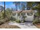 Beautiful white home with green shutters, complemented by mature trees and a well-maintained lawn at 2484 Oldfield Nw Rd, Atlanta, GA 30327