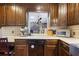 Traditional-style kitchen with wooden cabinets, stone accents, and modern appliances at 2484 Oldfield Nw Rd, Atlanta, GA 30327
