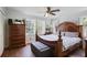 Well-lit main bedroom with a large bed, wood floors, and shuttered windows at 2484 Oldfield Nw Rd, Atlanta, GA 30327