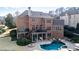 Aerial view of a brick home, large backyard, pool, and patio at 3195 Ne Wills Mill Ne Rd, Cumming, GA 30041