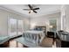 Serene bedroom with a ceiling fan, a balcony, and dark wood furniture at 3195 Ne Wills Mill Ne Rd, Cumming, GA 30041