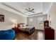 Cozy bedroom with tray ceiling, ceiling fan, hardwood floors, and two windows providing natural light and a peaceful ambiance at 3195 Wills Mill Rd, Cumming, GA 30041